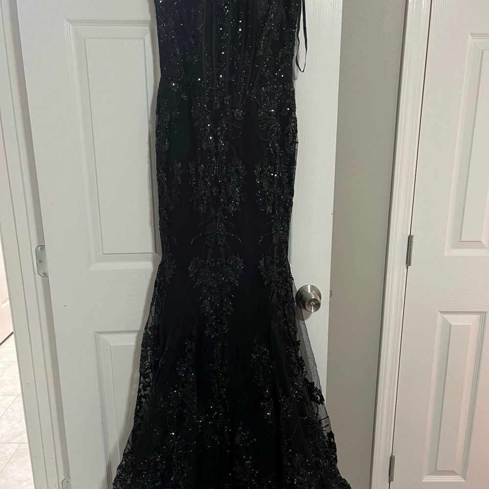 It’s a black beaded dress flare at the bottom open in the back